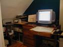 Check out a larger view of my new mini-office. The board across my desk drawer makes for a handy keyboard tray, especially since the gargantuan monitor takes up so much room.